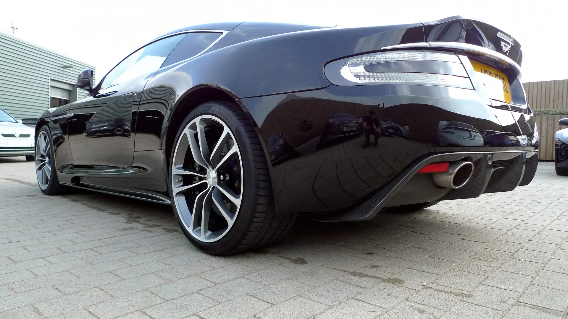 Black Aston Martin with a deep, glossy finish after a detail