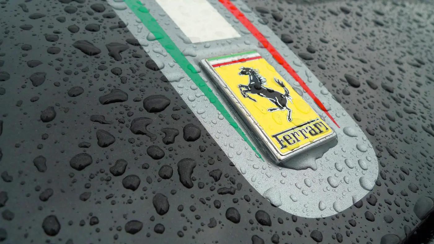 Water beading on a ceramic-coated Ferrari bonnet badge