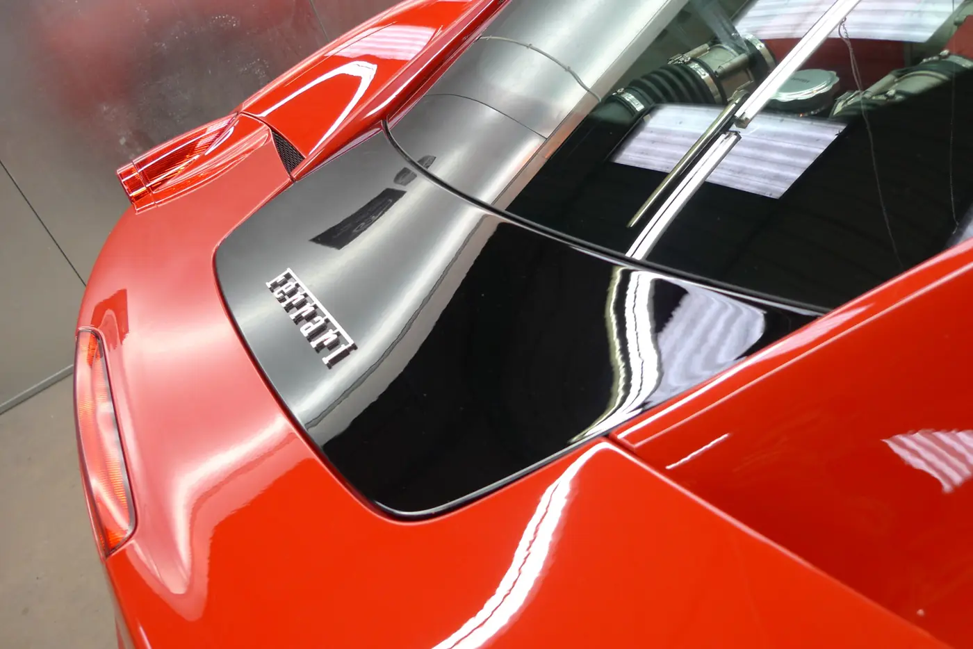 Close-up of the bonnet and headlight of a red Ferrari 458